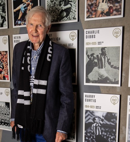 Harry Curtis's son, Bernard, with his father's photo on our Hall of Fame wall